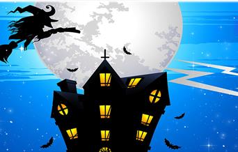 Witch flying over a darkened house with a large moon just above