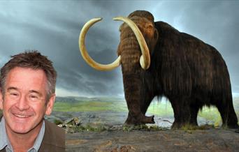 An illustration of a woolly mammoth with Nigel's headshot inserted