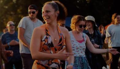 festival goers pictured laughing and enjoying their experience.