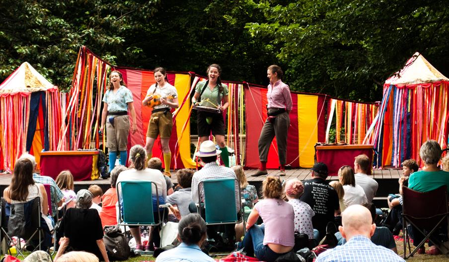 The theatre group pictured performing on an open air stage