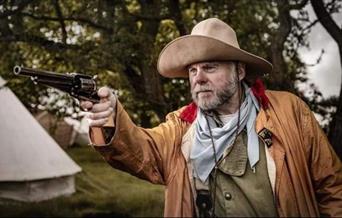 A wild west gun shooter pictured in full costume