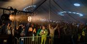 Festival goers inside a music tent