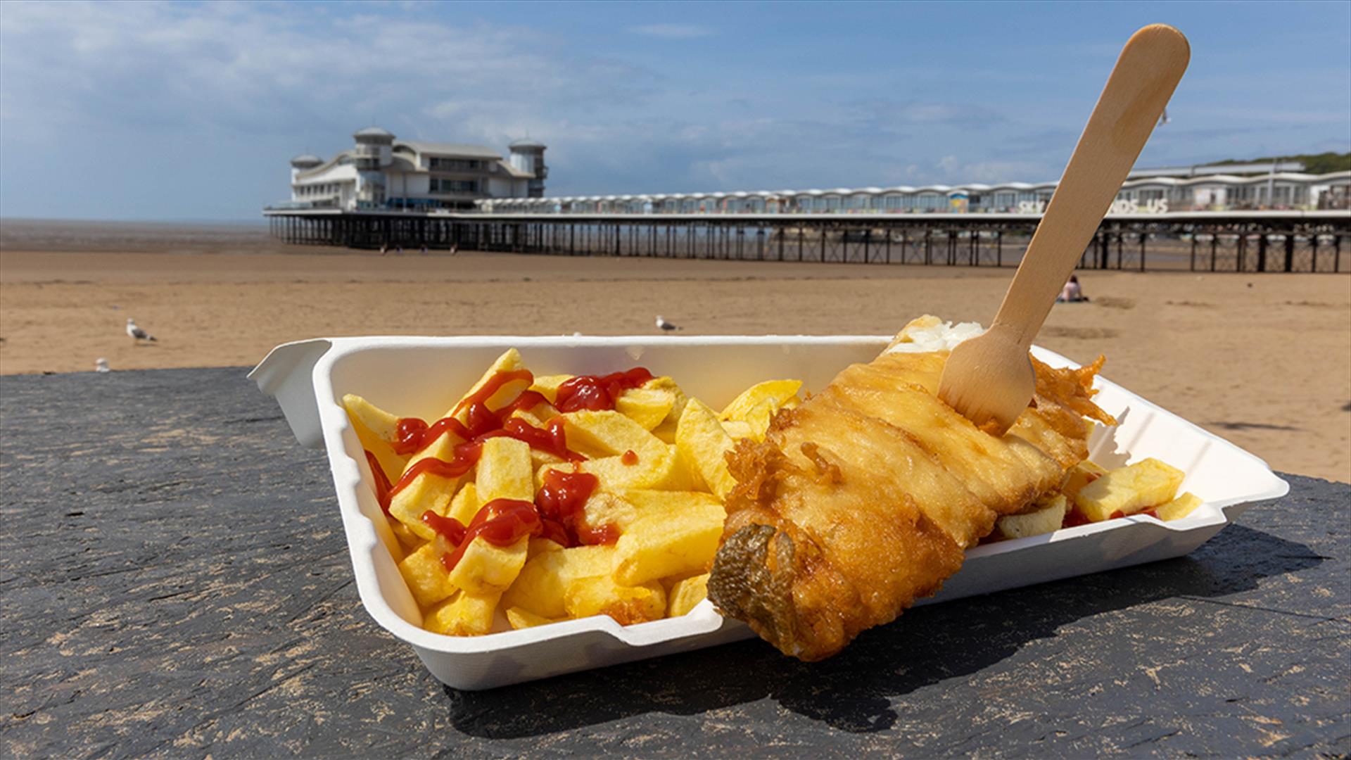 Fish supper on a table in front of the pier