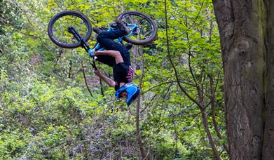 Bike rider upside-down as he tackles one of the jumps at the Sand Bay Dirt Jump track at Kewstoke