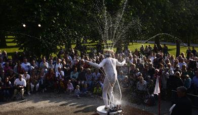 Photograph of Spurting Man on plinth, squirting water from his costume