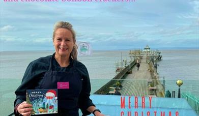 Lady on a pier holding an Advent calendar