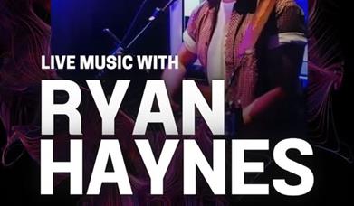 Musician Ryan Haynes singing into a microphone