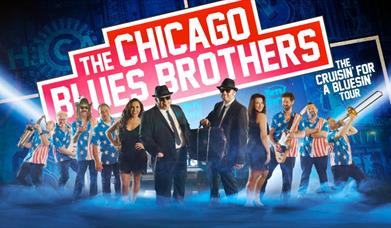 The Blues Brother with a band of musicians and a classic black car with a background of images of Chicago tinted blue.