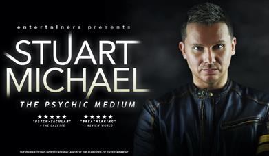 Stuart Michael on the right and the title in white glowing on the left.