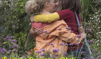 3 children talk together in a wild garden. Image reads Trigger Summer Club 29th July - 2nd August Book Now!