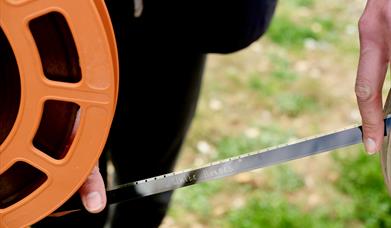 Reel of film, writing on the film are the words 'White Horses