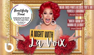 La Voix smiling as she appears from a golden photo frame