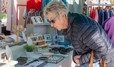 A lady browsing the jewellery store at the Weston-super-Mare weekly market