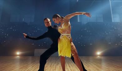 A ballroom dancing couple performing