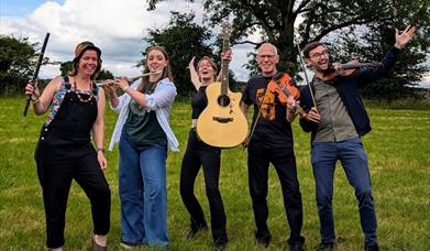 The five members of the Barnstormers band with their instruments