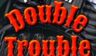 Double Trouble written in red on the back of bikers' jacket