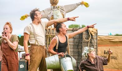 Four actors from the Farmyard Circus Group looking shocked as they point to something in the distance