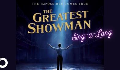 The Greatest Showman Sing-a-Long poster with an individual standing underneath a spotlight.