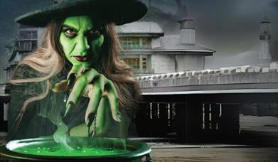 A witch with her cauldron outside the Grand Pier Weston-super-Mare