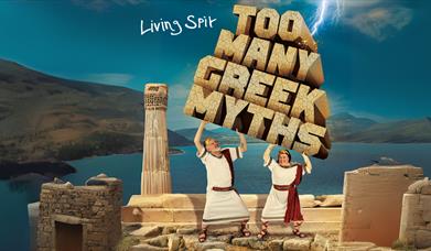 Cartoon style image featuring two men in white togas lifting up stone blocks spelling out the words Too Many Greek Myths while standing on top of an a