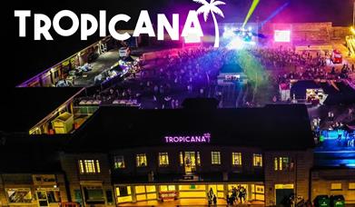 Aerial view of the Tropicana night time venue all lit up with disco lights