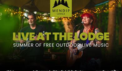 Two musicians (man and woman) playing guitar and singing into microphone under tented woodland canopy. Mendip Lodge logo. Text promotes Live at the Lo