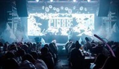 People playing bingo in front of a big screen