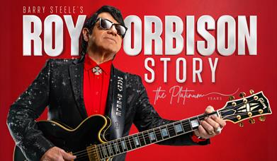 Red poster advertising the Roy Orbison Story at the Weston Playhouse. The poster features a guitarist looking like the singer