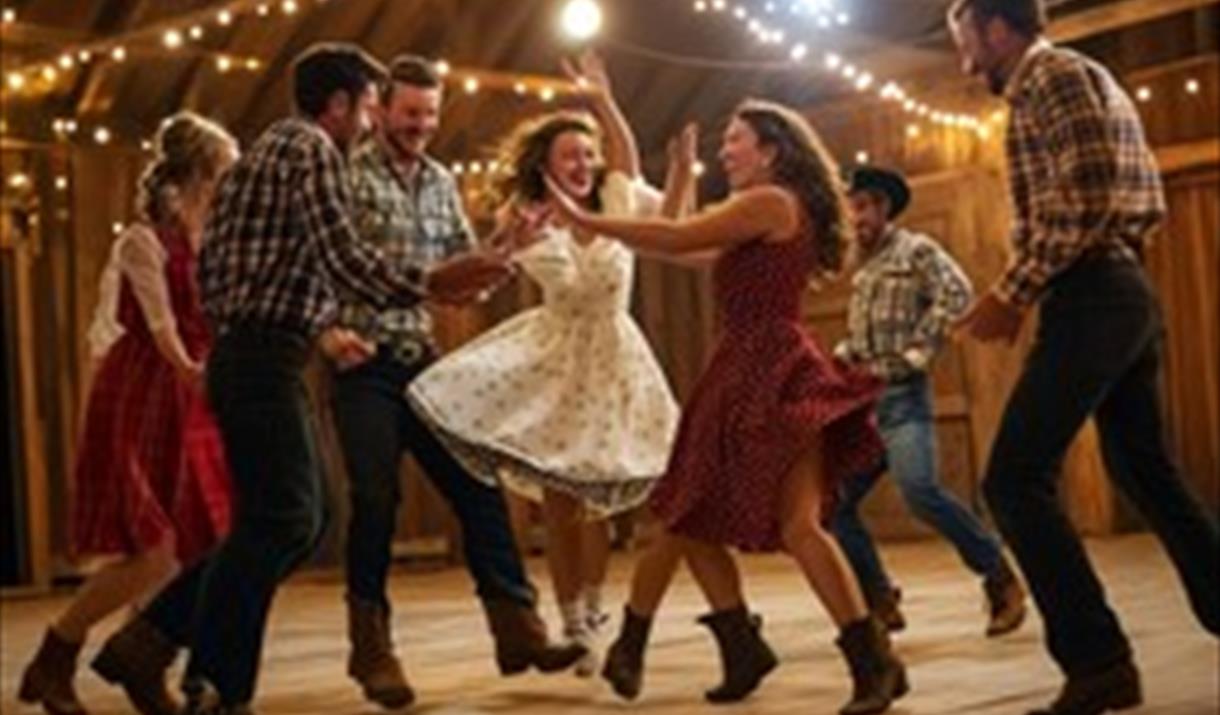 Men and women dancing at a barn dance