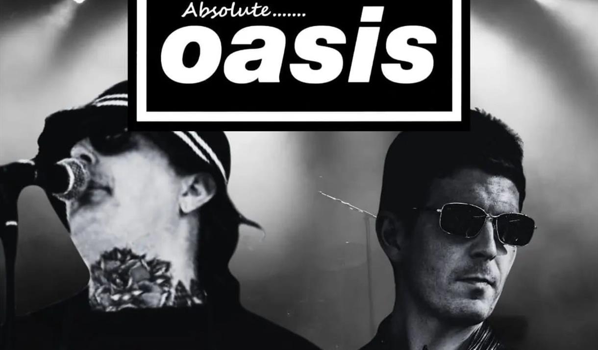 Black and white photo of two members of the Absolute Oasis tribute band performing