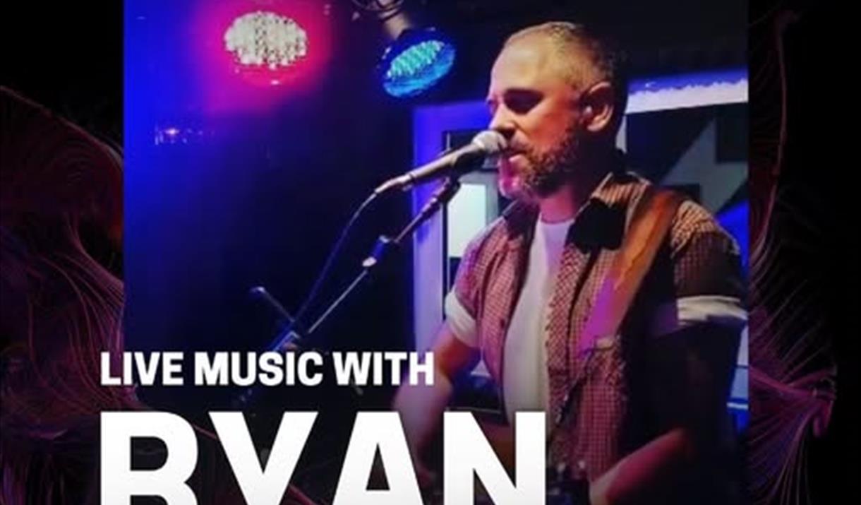 Musician Ryan Haynes singing into a microphone