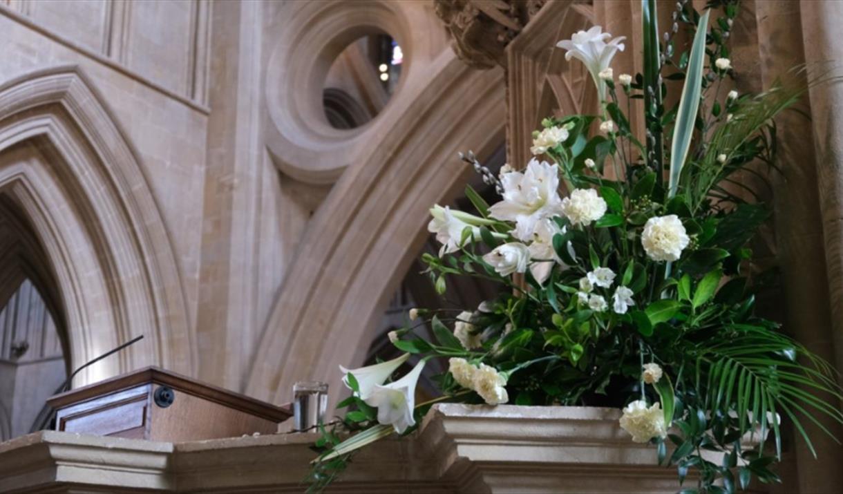 A large bouquet of white flowers in a church