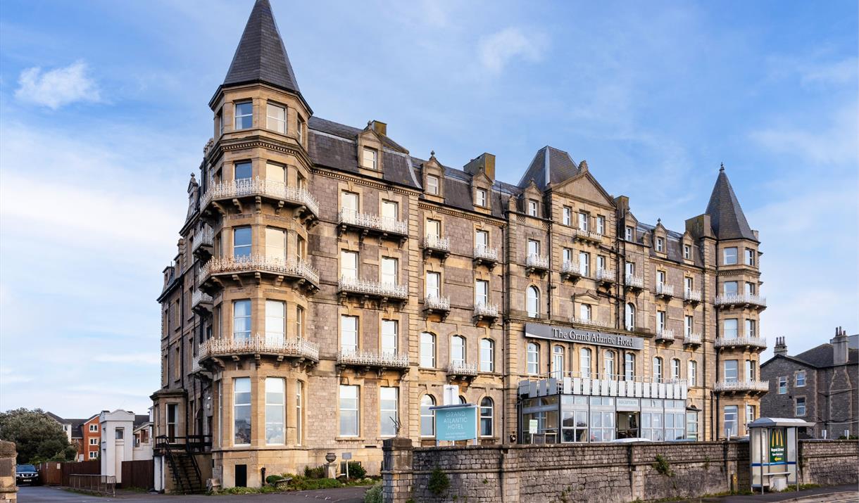 Exterior of a big four-storey hotel with turrets on the corners