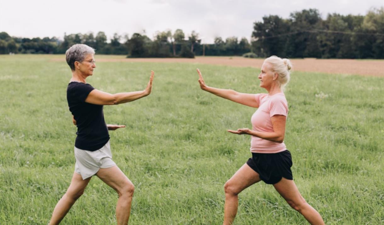 Women doing Tai chi outdoors