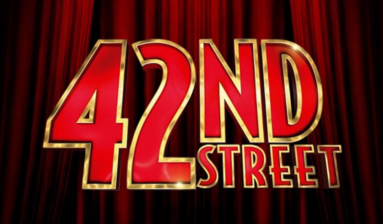 The musical title 42nd Street in red and gold letters with theatre curtains behind