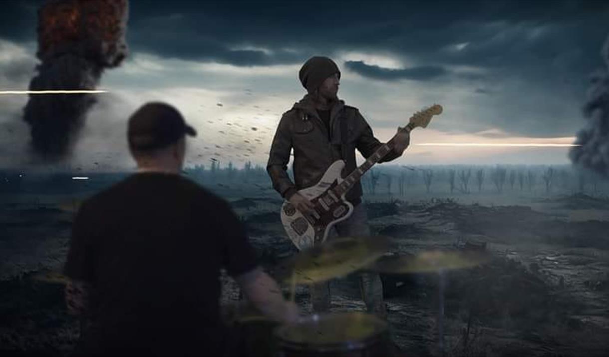 guitarist in dark open landscape, crows and ominous people surrounding.