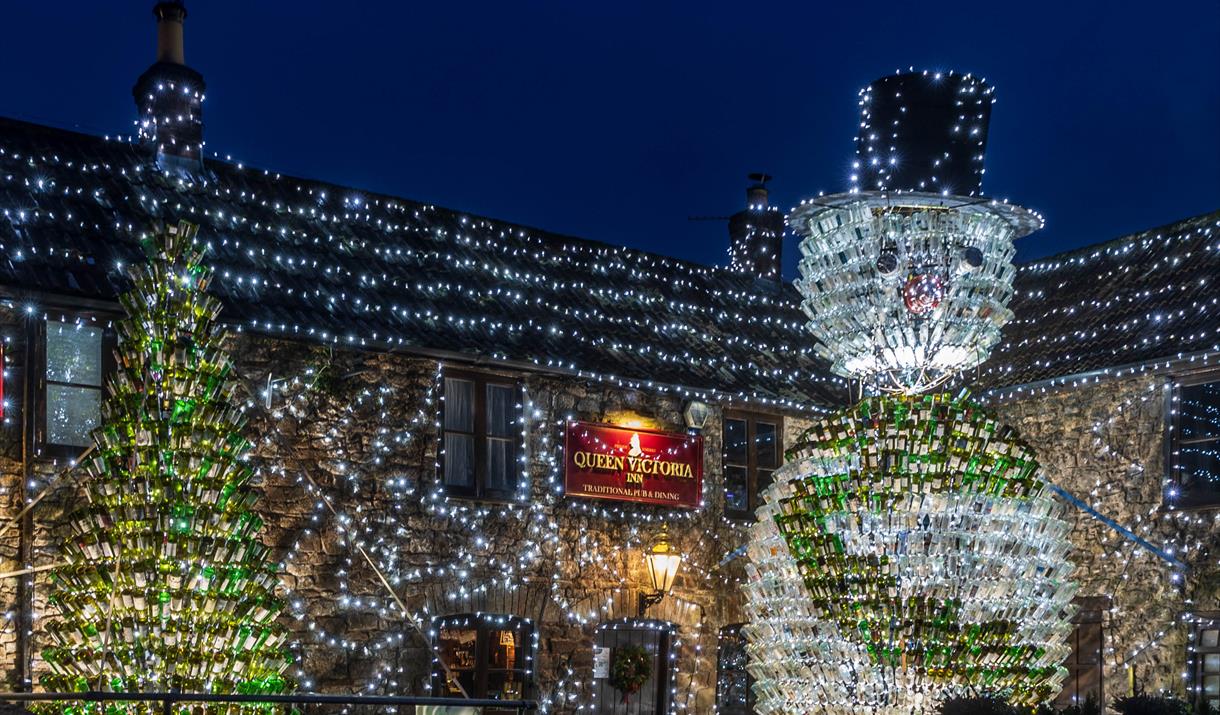 The Queen Victoria pub in Priddy and its famous Christmas Lights display featuring a giant 26ft tall snowman made out of 2,500 empty wine bottles and