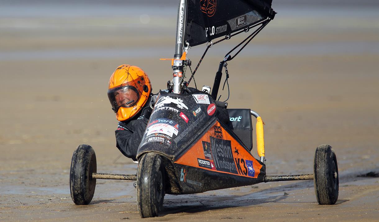 Close up of a blokart racer in his three wheeled kart