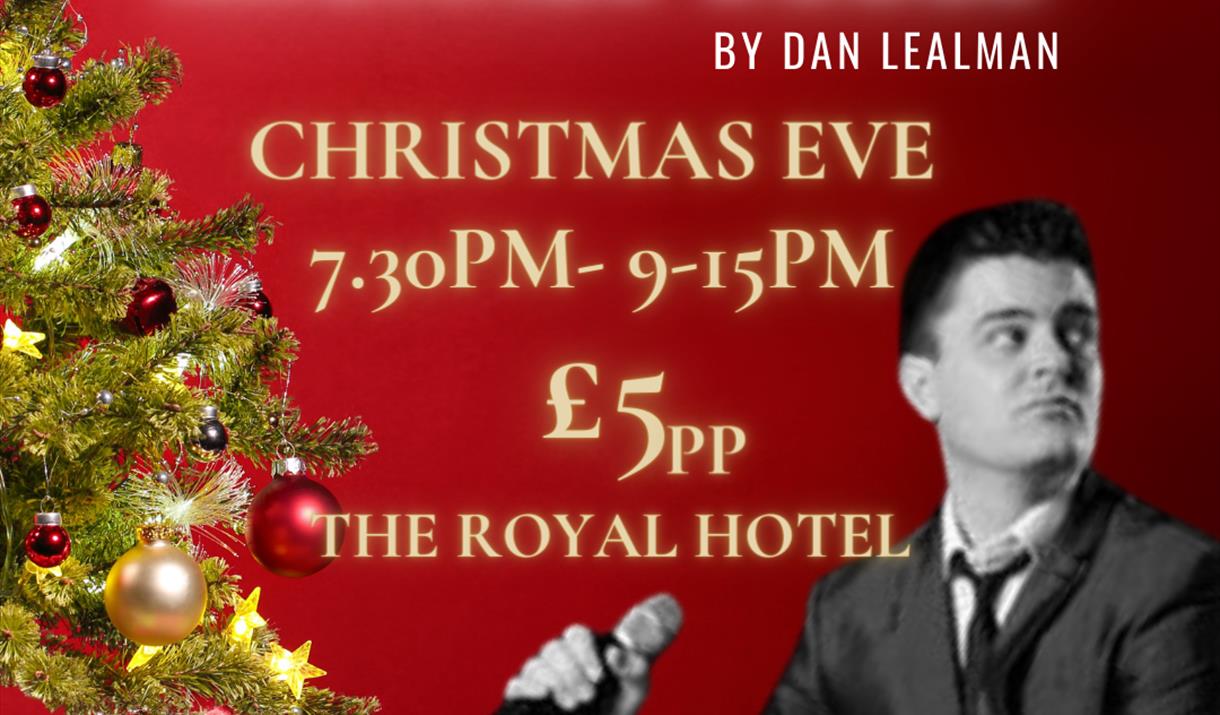 An evening of Michael Buble by Dan Lealman.  Photograph of Dan with a green Christmas tree and presents underneath the tree.