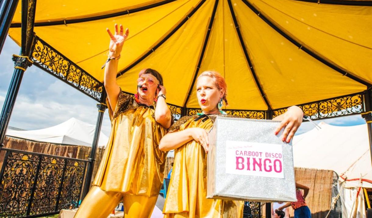 Singers wearing yellow on the bandstand