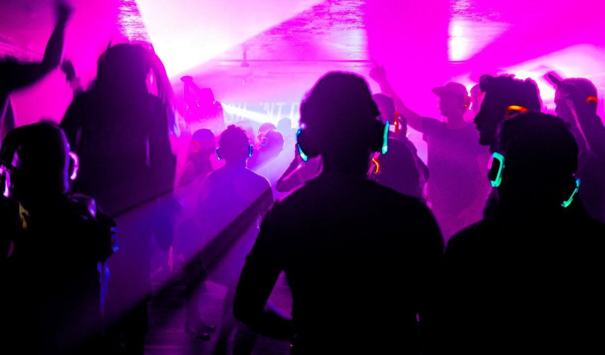People wearing headphones and dancing at a silent disco
