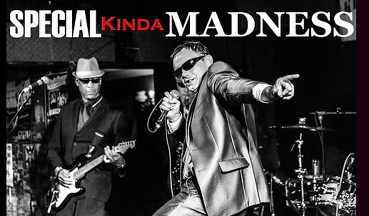 Black and white photo of two members of the music tribute act Special Kinda Madness performing on stage