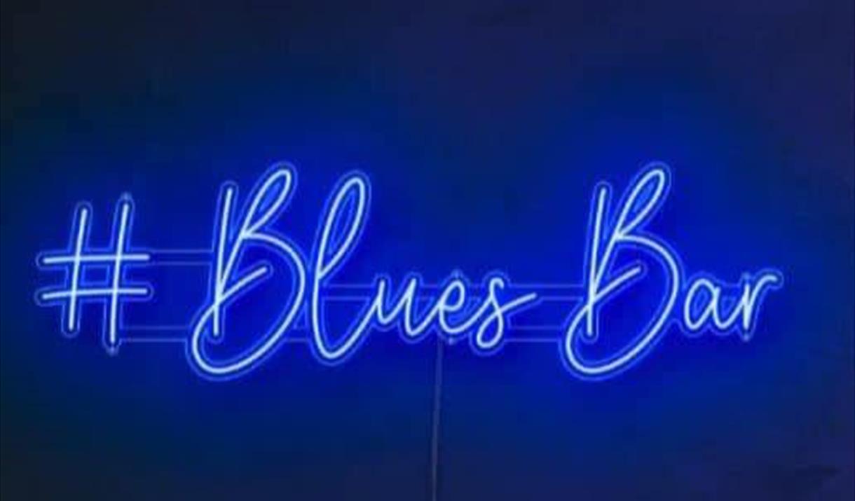 Blues bar lit up in neon lights