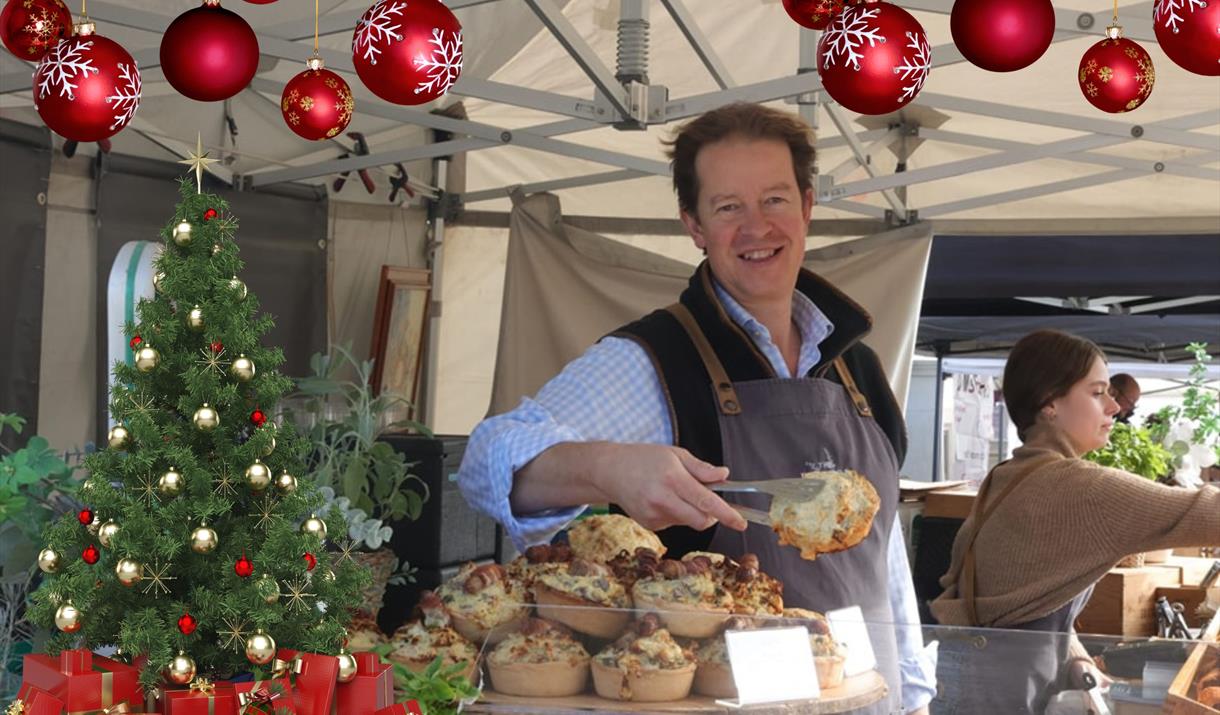 A stallholder serving up a savoury delight at the Eat:Weston food festival on his stall which is decorated with Christmas baubles and a Christmas tree