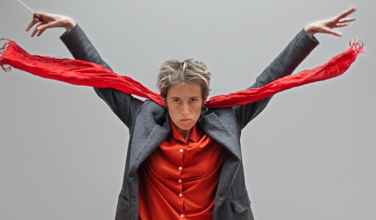 Photograph of Boorish wearing a bright red shirt and scarf.