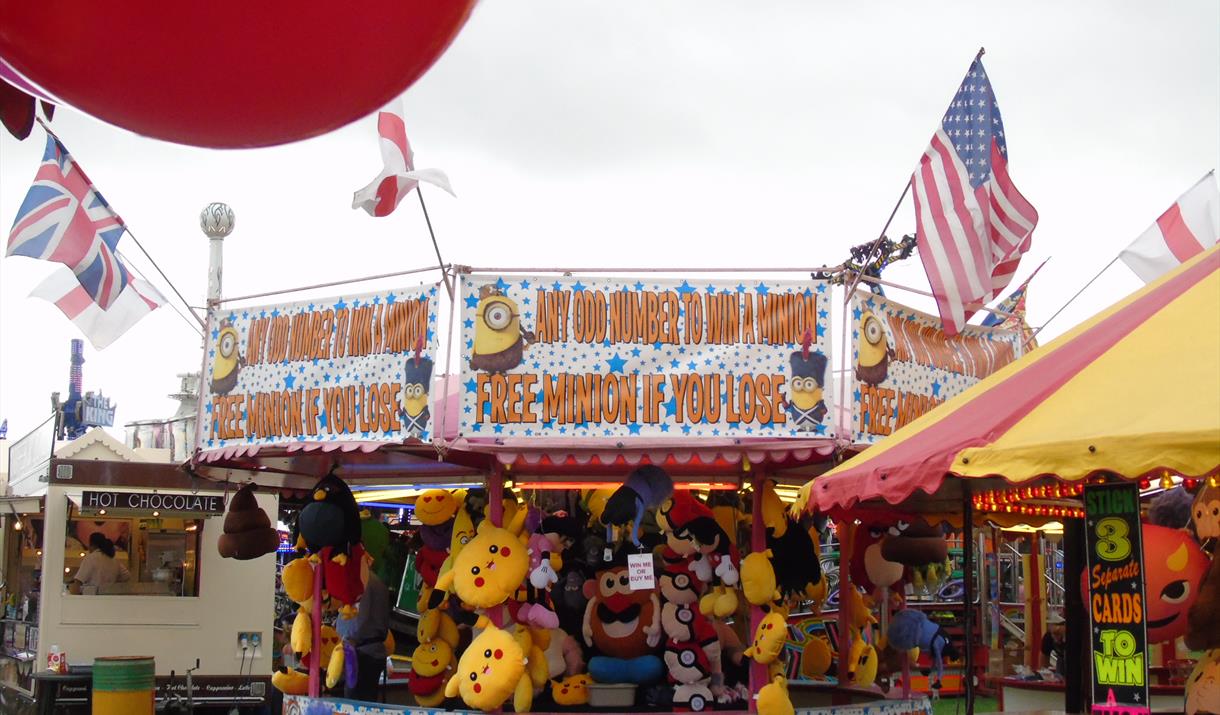 image shows fairground attractions, teddy bear stand