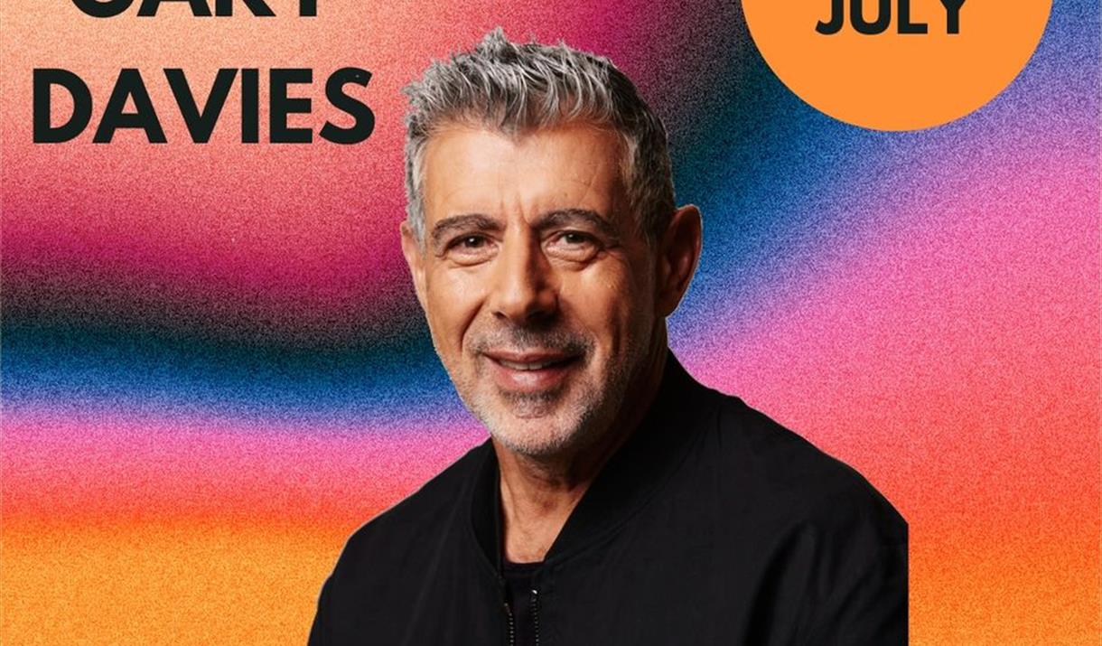 Mug shot of DJ Gary Davies against a colourful backdrop