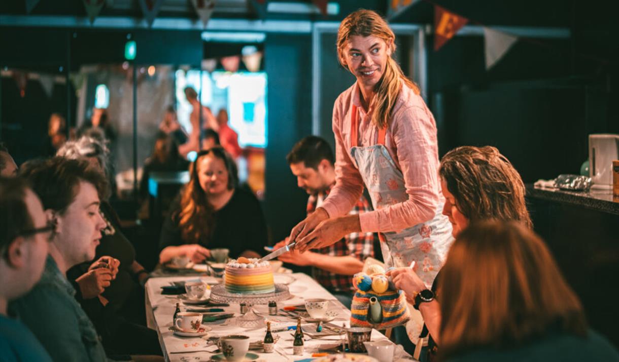 Photograph of Tom Marshman hosting a tea party.