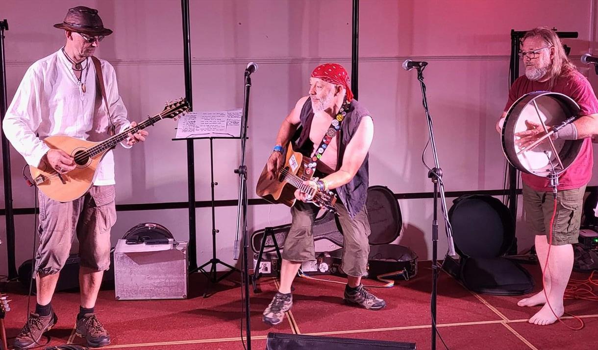 Brian Stone and band performing on stage with guitars and drums