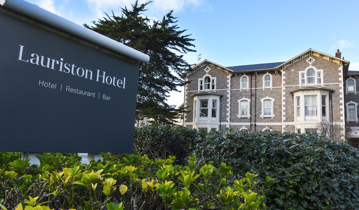 Exterior of the hotel with large grey sign saying Lauriston Hotel on a grey background